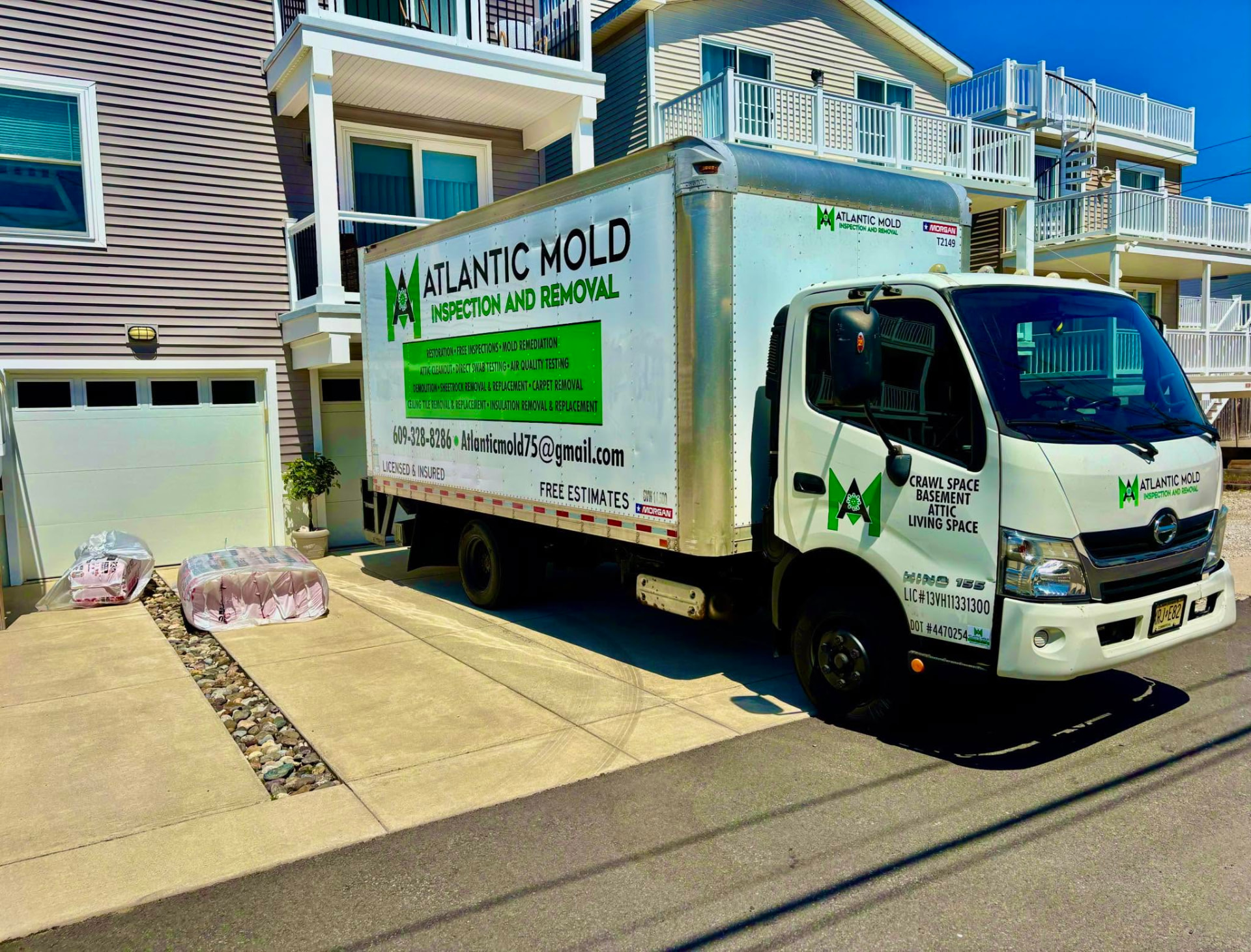 Atlantic Mold Inspection and Removal box truck parked at a shore home job site in South Jersey
