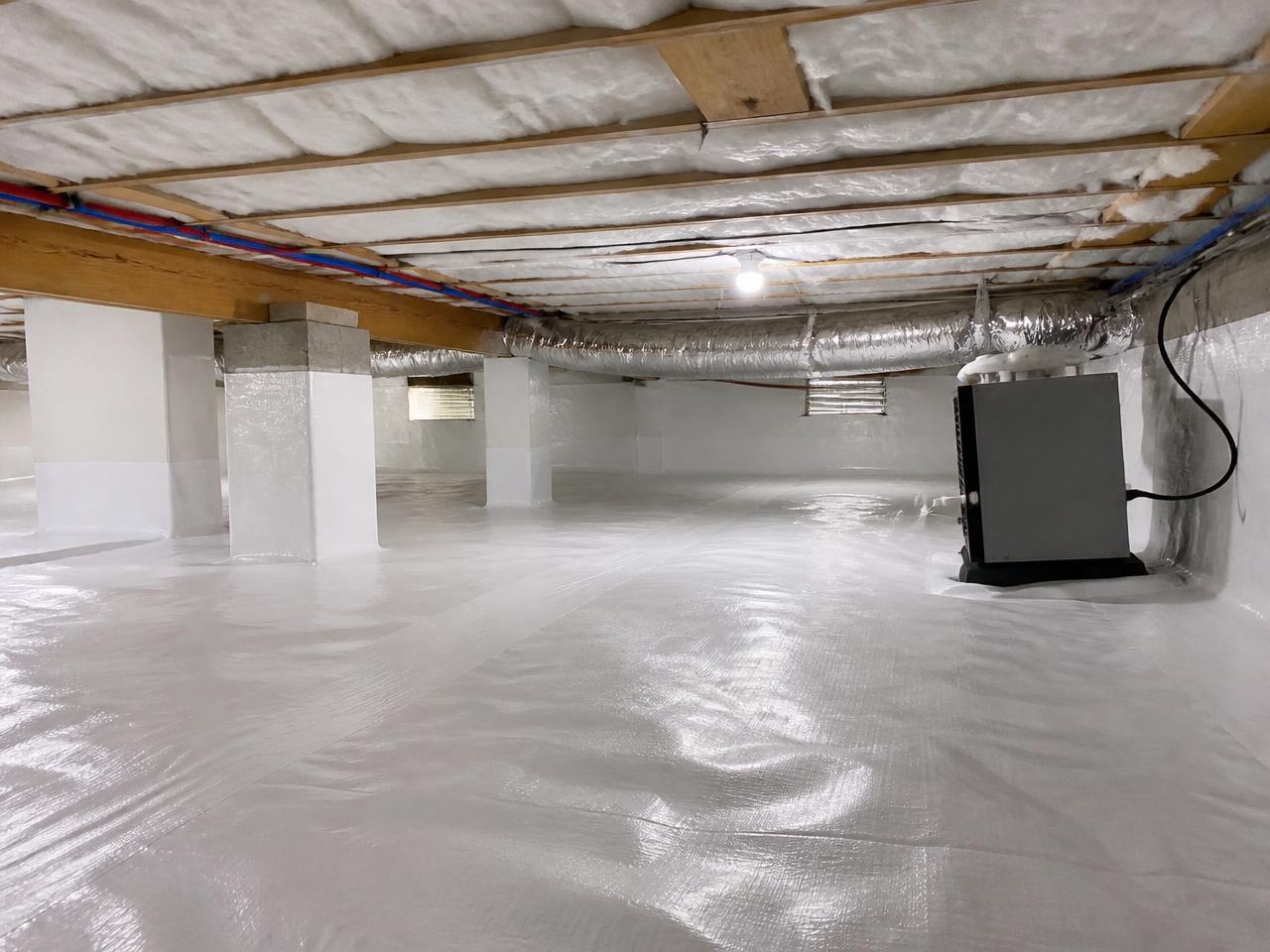 Clean crawl space with a white vapor barrier, new insulation and a dehumidifier after remediation
